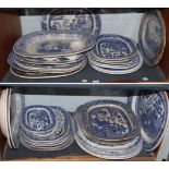 A large quantity of transfer printed blue and white Staffordshire meat plates (a.f.) (two shelves)