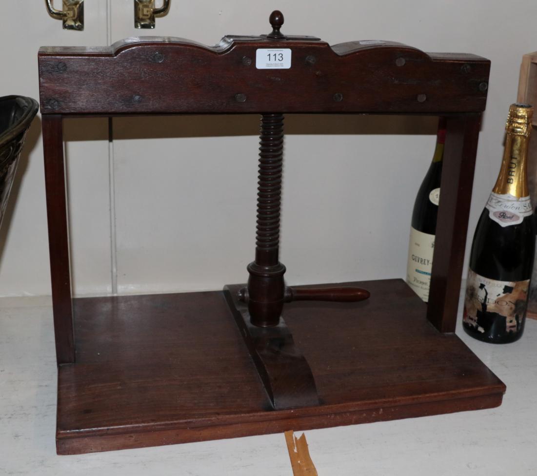 An early 19th century mahogany press with turned handle