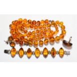 An amber type suite comprising a necklace, a bracelet, a ring; and a pair of drop earrings . All