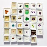 A quantity of loose gemstones including amethyst, peridot, garnet, rock crystal, haematite, jade,