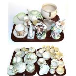 A collection of Belleek ceramics including: teapots; bowls; small baskets; cups and saucers; two