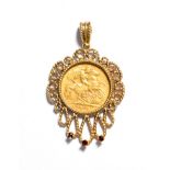 A 1912 half sovereign loose mounted as a pendant in a gemset frame, length 4.5cm