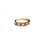 A 9 carat gold ruby and diamond half hoop ring, total estimated diamond weight 0.15 carat