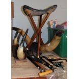 Two pairs of large mounted cow horns; a folding hunting stool; three white metal mounted walking