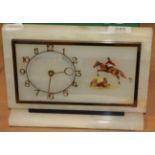 An Art Deco alabaster mantel timepiece with show jumping subject