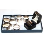 A collection of eight various silver napkin-rings, including one cased, some variously engraved, 7oz