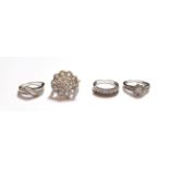 A large silver diamond set cluster ring, finger size R1/2; and three other silver diamond set