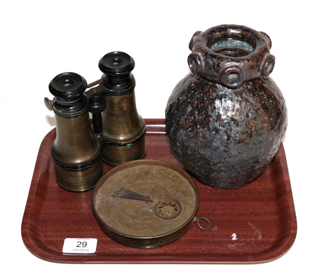 A pair of binoculars; a Middle Eastern brass astrolabe; and a Studio pottery vase