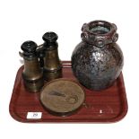 A pair of binoculars; a Middle Eastern brass astrolabe; and a Studio pottery vase
