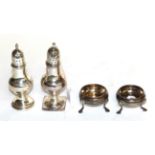 A pair of George III silver salt-cellars and two George III silver pepperettes, the salt-cellars