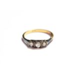 A diamond three stone ring, stamped '18CT, finger size Q. Gross weight 2.9 grams.