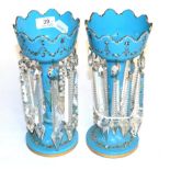 A pair of enamel decorative blue glass table lustres