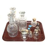 A collection of silver-mounted cut-glass scent-bottles and jars, including two with pale blue