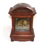 An oak cased striking mantel clock with brass dial, circa 1900