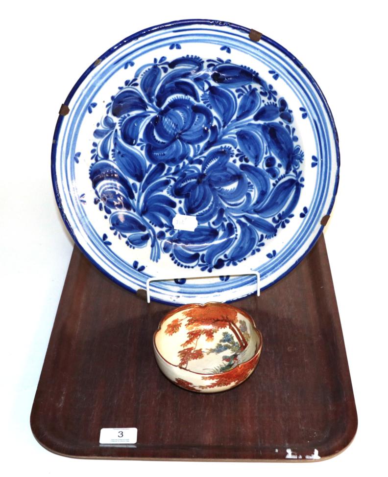 A Delft blue & white charger, floral pattern, marked 'W.M.D.' to underside, 34.5cm diameter;