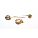 An 18 carat gold diamond set stick pin; a seed pearl horseshoe stick pin; and a cameo pendant,