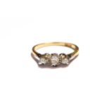 A diamond three stone ring, stamped '18CT', finger size N1/2. Gross weight 2.1 grams