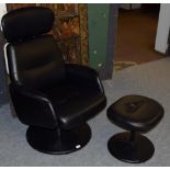 A modern black swivel chair and footstool