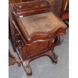 A Victorian carved walnut Davenport (a.f.)