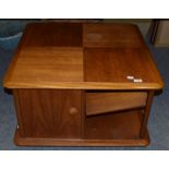 A 1970s 'Nathan' teak low coffee table with cupboard doors, raised on wheels