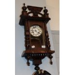 A small mahogany Vienna type striking wall clock