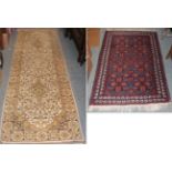 A Baluch rug, the field of flower head lattice design enclosed by raspberry borders, 135cm by