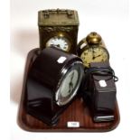 A Smith electric mantel timepiece; a Smiths Enfield bakelite mantel timepiece; a carved oak cased