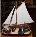 A 20th century model pond yacht on stand; together with a wooden model of a ship and a ship in a