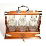 A silver plated three bottle tantalus