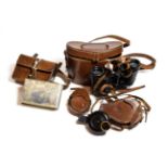 Four leather cased items including two H Hughes and Son's Ltd Military compasses, a cigarette