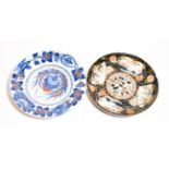 A Kangxi blue and red porcelain dish, floral ground and border, artemesia leaf mark to base, 27cm