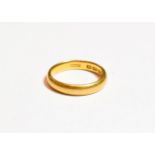 A 22 carat gold band ring, finger size P1/2. Gross weight 5.7 grams.