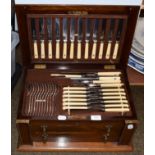 An early 20th century oak canteen of silver plated cutlery, twelve settings