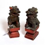A pair of Chinese temple lions on integral plinth bases, late 19th/early 20th century (2)