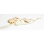 An early 20th Century German bisque figure of a nude young woman, unmarked, modelled stretching with