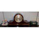 An early 20th century mahogany triple train mantel clock; together with a German porcelain figural