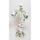 A German porcelain floral encrusted four light candelabra