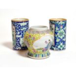 A pair of Chinese sleeve vases floral decorated on a blue ground with panels of birds amongst