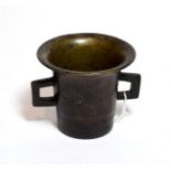 A bronze mortar, possibly German, 16th/17th century, of flared cylindrical form with angular handles