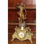 A green onyx and spelter figural striking mantel clock