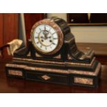 A Victorian black slate and marble striking mantel clock with visible Brocot escapement