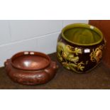 A Bretby Art Pottery jardiniere, decorated with dragons and the flaming pearl, in greens, yellow and
