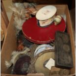 A box of miscellaneous including a pop-up top hat, various frames, feathers and other decorative