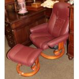 An Ekornes Stressless leather swivel chair, with matching footstool