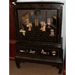 A 20th Century Chinese black lacquered and painted hard stone and bone inlaid cabinet on stand.