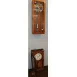A 1950's Inducta pendulum wall clock, together with a late Victorian oak cased wall clock, with