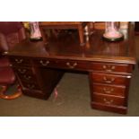 An early 20th Century mahogany partners desk, with brown leather writing surface, 151cm wide