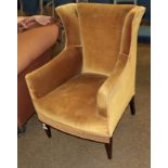 A Victorian armchair upholstered in yellow velvet on square tapering legs