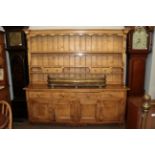 A pine dresser with associated plate rack, 208cm wide