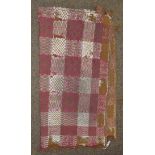 A 19th century Welsh wool blanket, worked in an olive green, pink and white checked design,